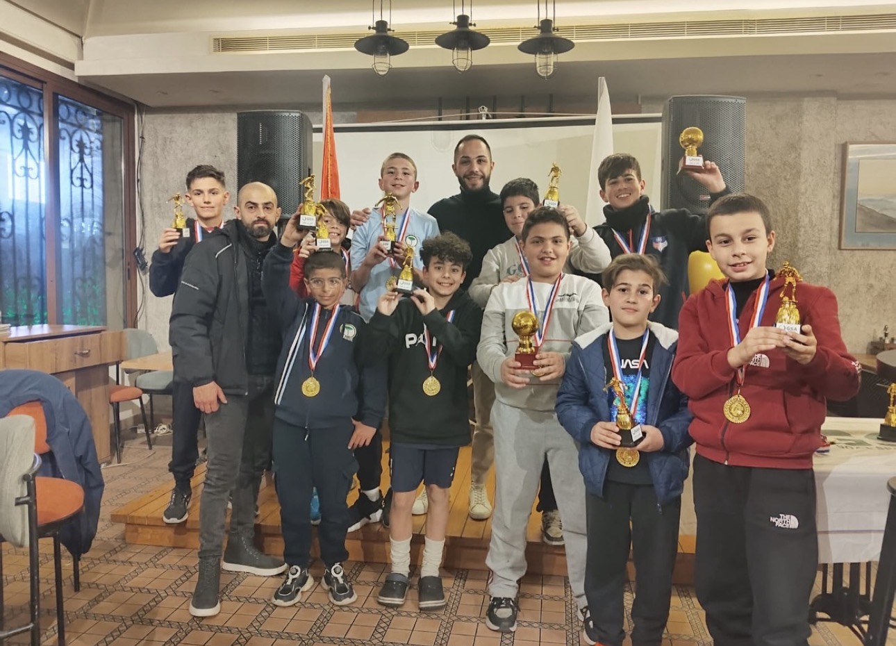 Young chess champions holding their trophies at Beit Setelkel